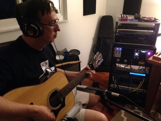 Bill Cote with acoustic guitar in studio